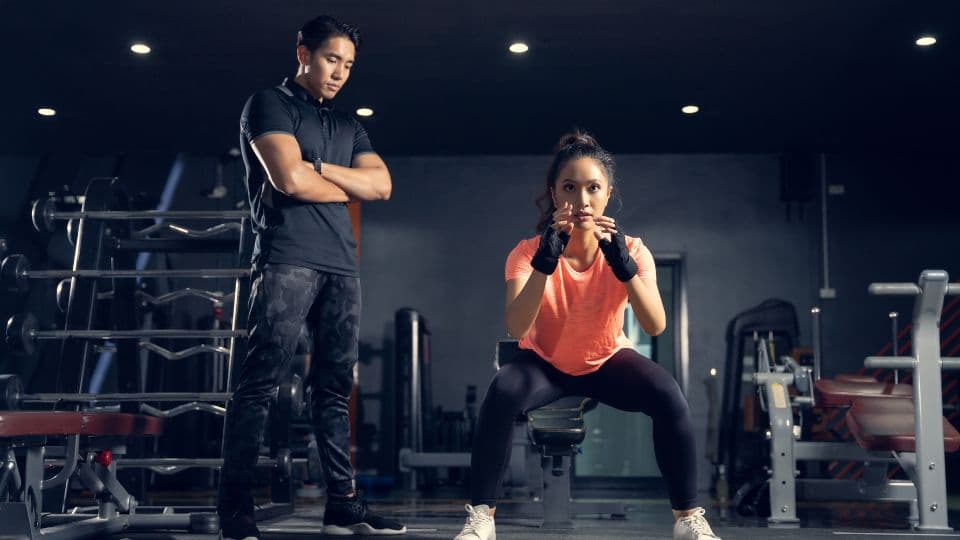 Personal trainer coaching client